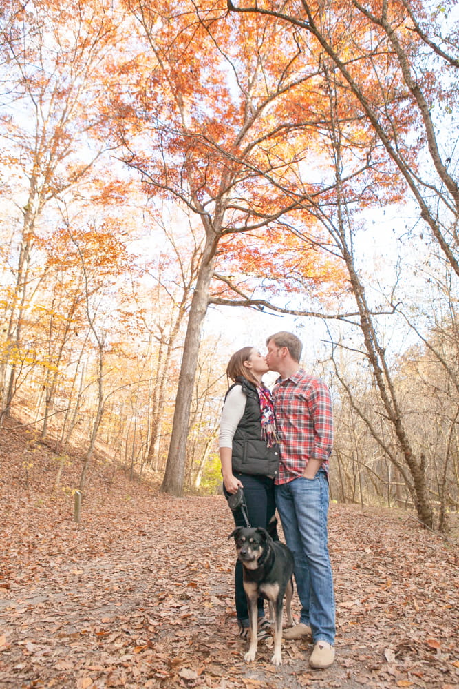 man and woman engagement picture with dog
