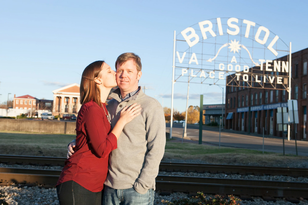man and woman engagement picture with Bristol Sign