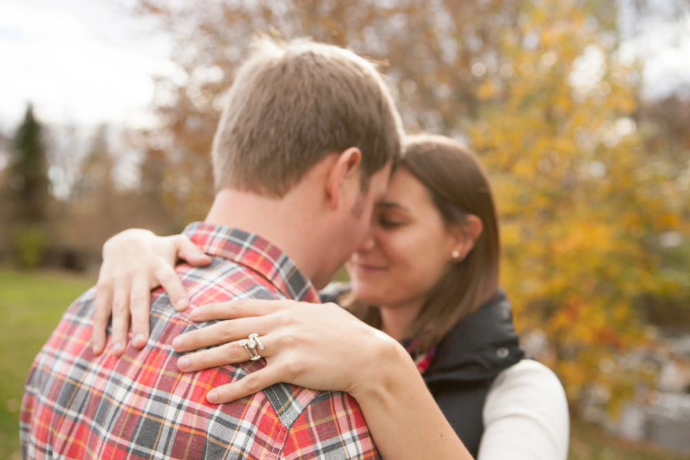 man and woman engagement picture with ring