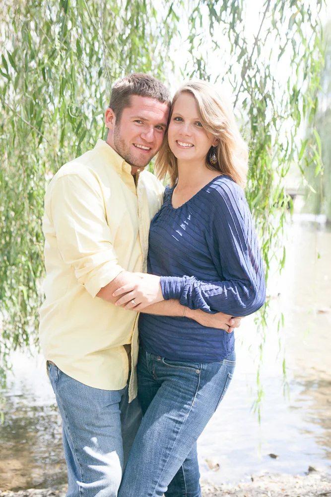 man and woman engagement image under tree