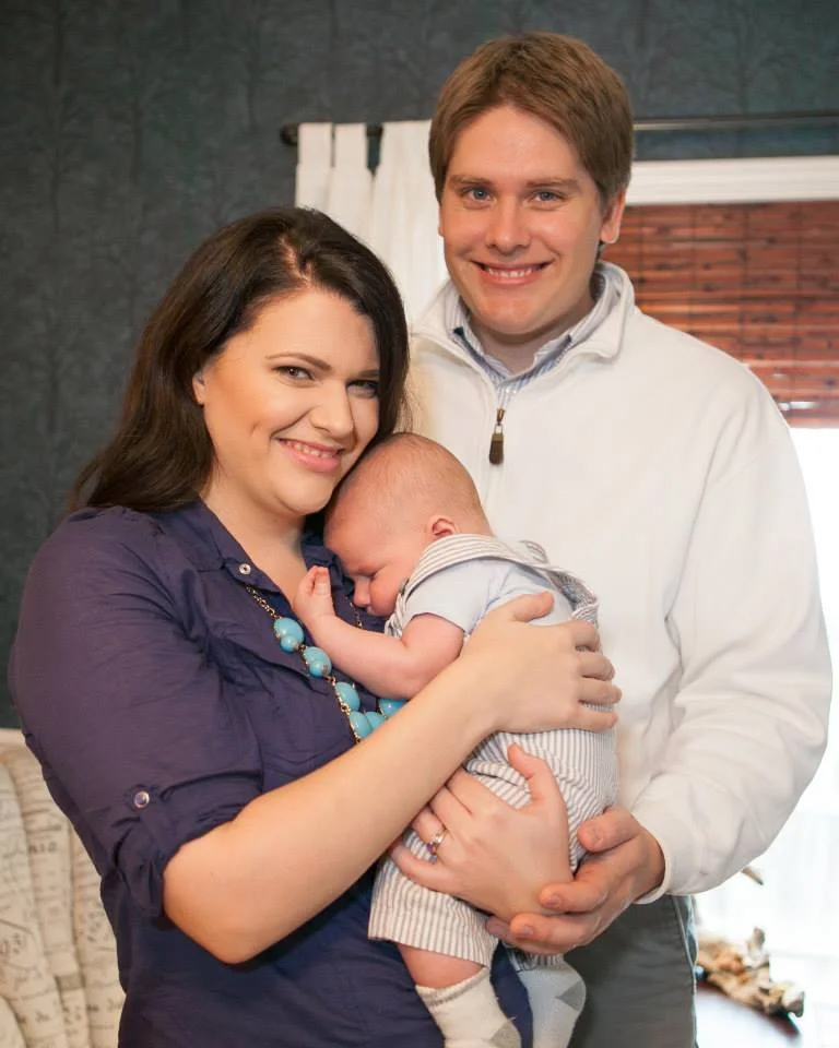 man and woman with baby