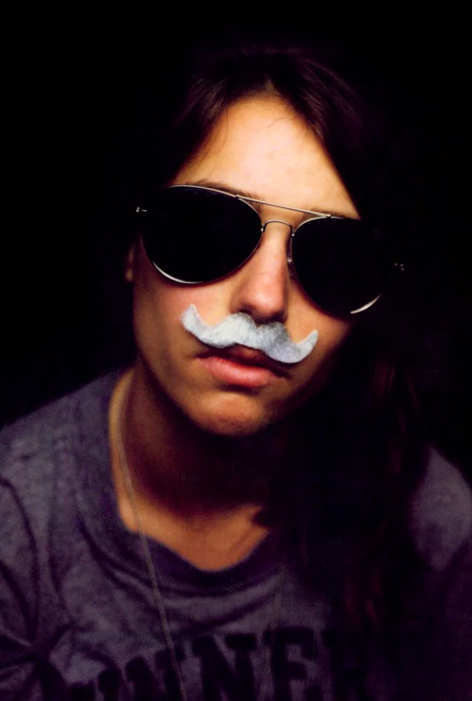 headshot of girl in fake mustache