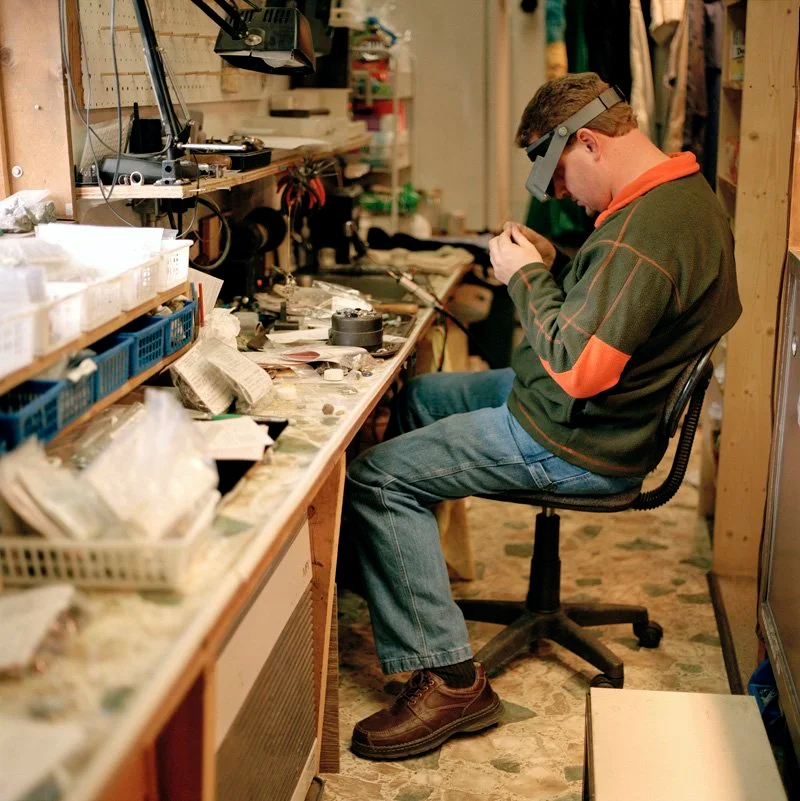 man working on cutting rocks with helmet