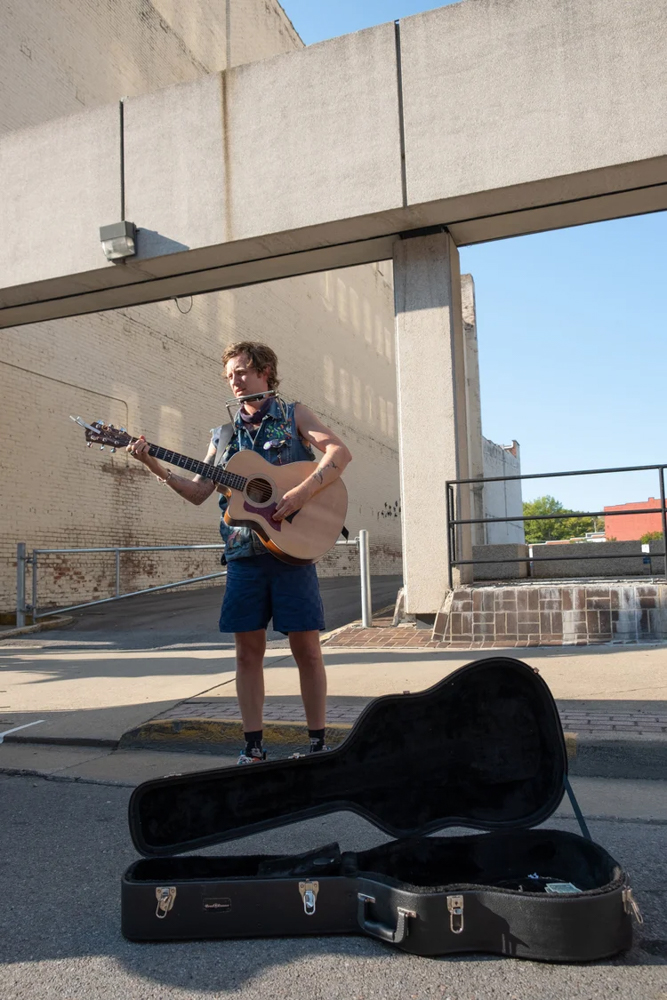 man busking on street